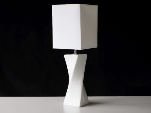 Nowoczesna lampka do sypialni ze skręconą ceramiczną podstawą i białym perkalowym abażurem o przekroju kwadratowym.